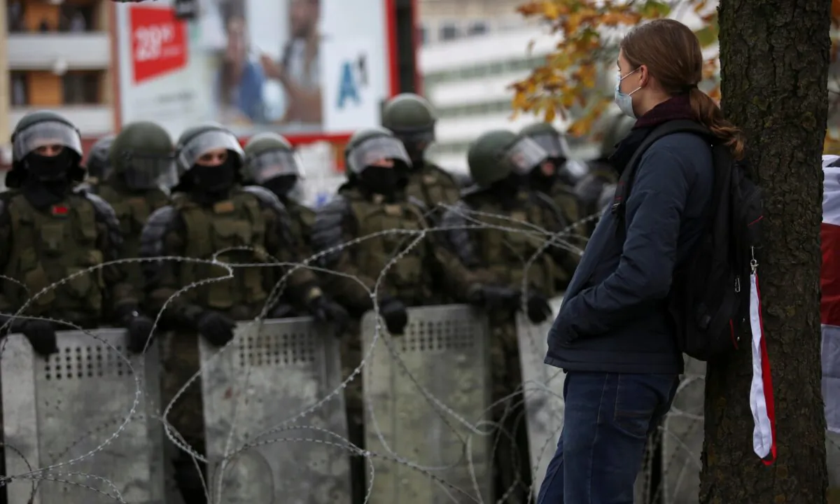 Belarusian service members stand guard during an opposition rally to reject the presidential election results in Minsk, on Oct. 25, 2020. (Stringer/Reuters)
