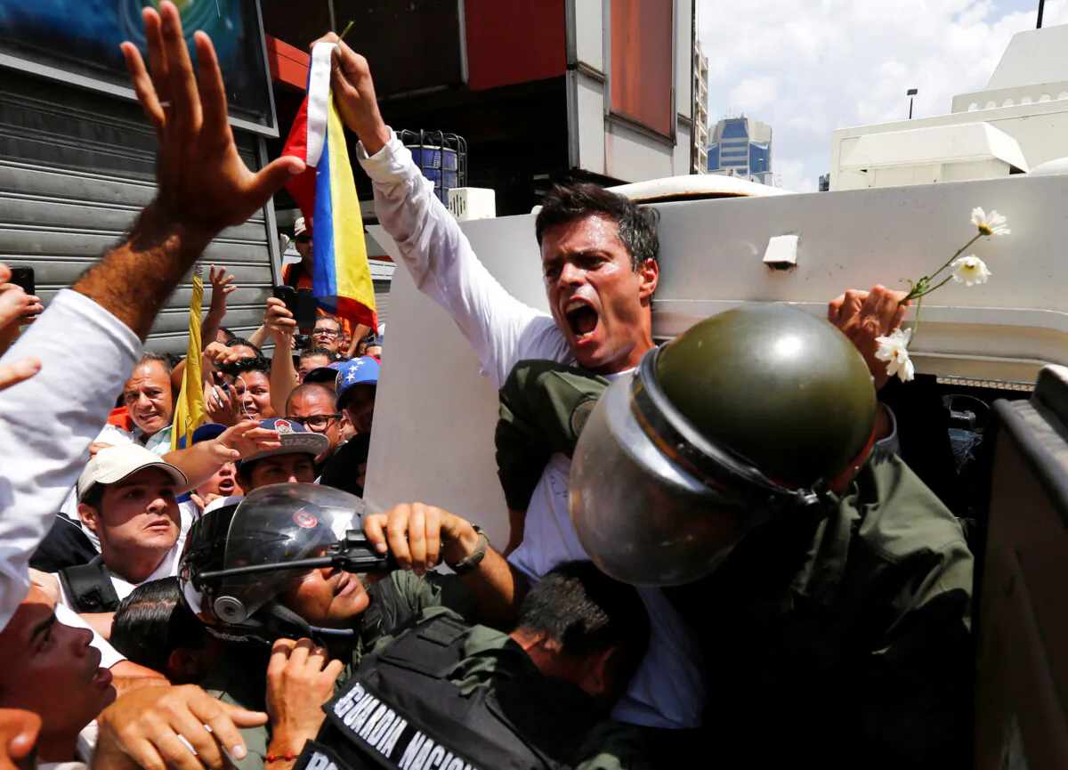 Venezuelan opposition leader Leopoldo Lopez gets into a National Guard armored vehicle in Caracas, on Feb. 18, 2014. (Jorge Silva/Reuters)
