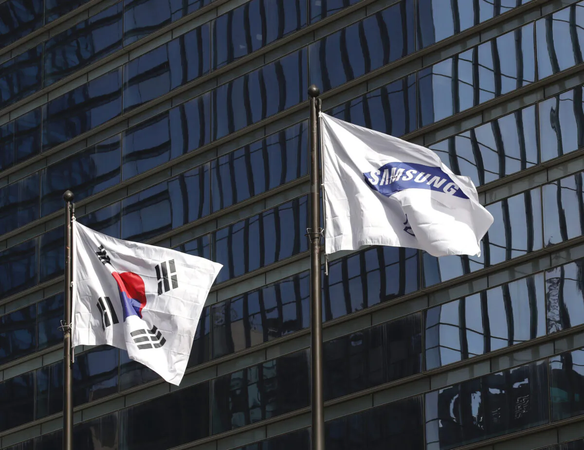 A flag of Samsung flutters next to the South Korean national flag outside of Samsung's Seocho office building in Seoul, South Korea, on Oct. 25, 2020. (Lee Jin-man/AP Photo)