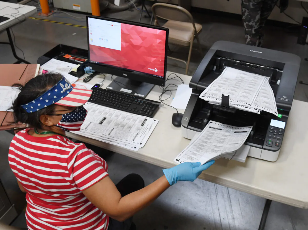 An  election worker scans mail-in ballots in a file photo. (Ethan Miller/Getty Images)