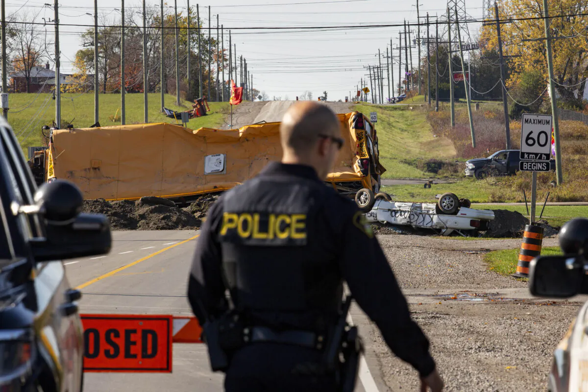 Ontario Provincial Police stand near a blockade on Argyle St. South in Caledonia, Ont., after a judge granted a permanent injunction against a land reclamation camp known as 1492 Land Back Lane, on Oct. 23, 2020. (The Canadian Press/Tara Walton)