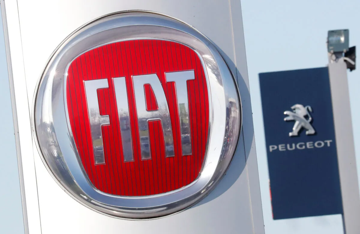 The logos of car manufacturers Fiat and Peugeot are seen in front of dealerships of the companies in Saint-Nazaire, France, on Nov. 8, 2019. (Stephane Mahe/Reuters)