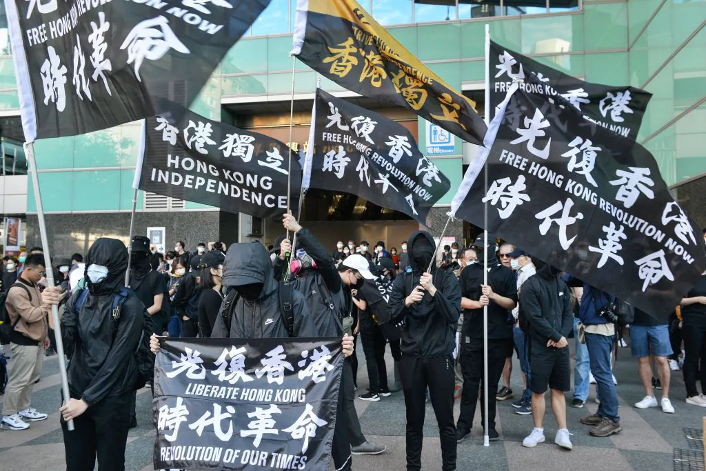 People holding up flags take part in a march in Taipei, Taiwan, on Aug. 25, 2020. (Chris Stowers/AFP via Getty Images)