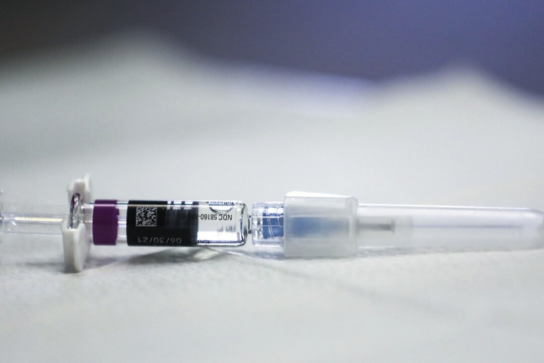 A flu vaccine syringe rests on a table at a free flu vaccination clinic held at a local library in Lakewood, Calif., on Oct. 14, 2020. (Mario Tama/Getty Images)