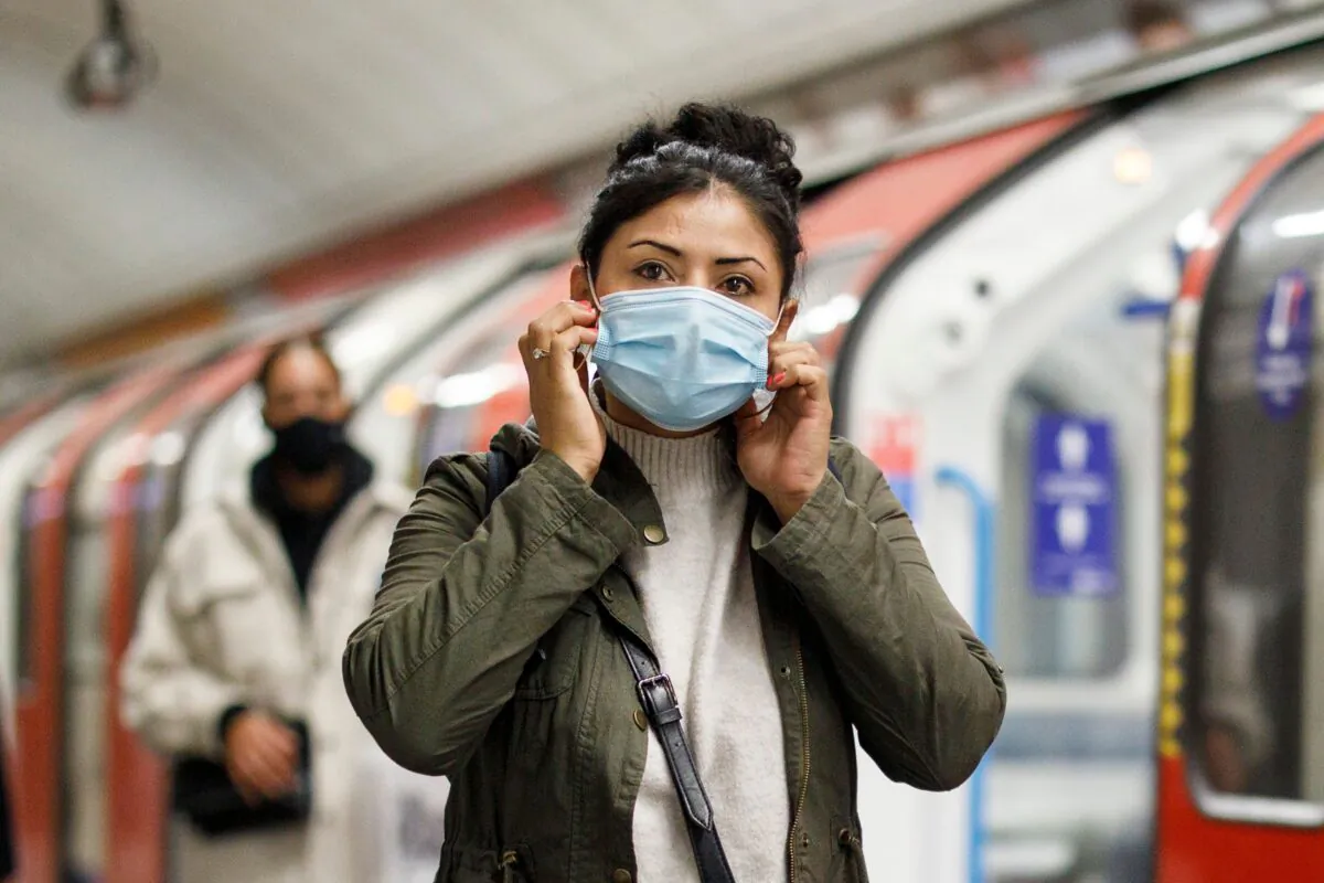Commuters wear face-masks during the morning rush hour on the Victoria Line of the London Underground in central London on Oct. 16, 2020, (Tolga Akmen /AFP/Getty Images)