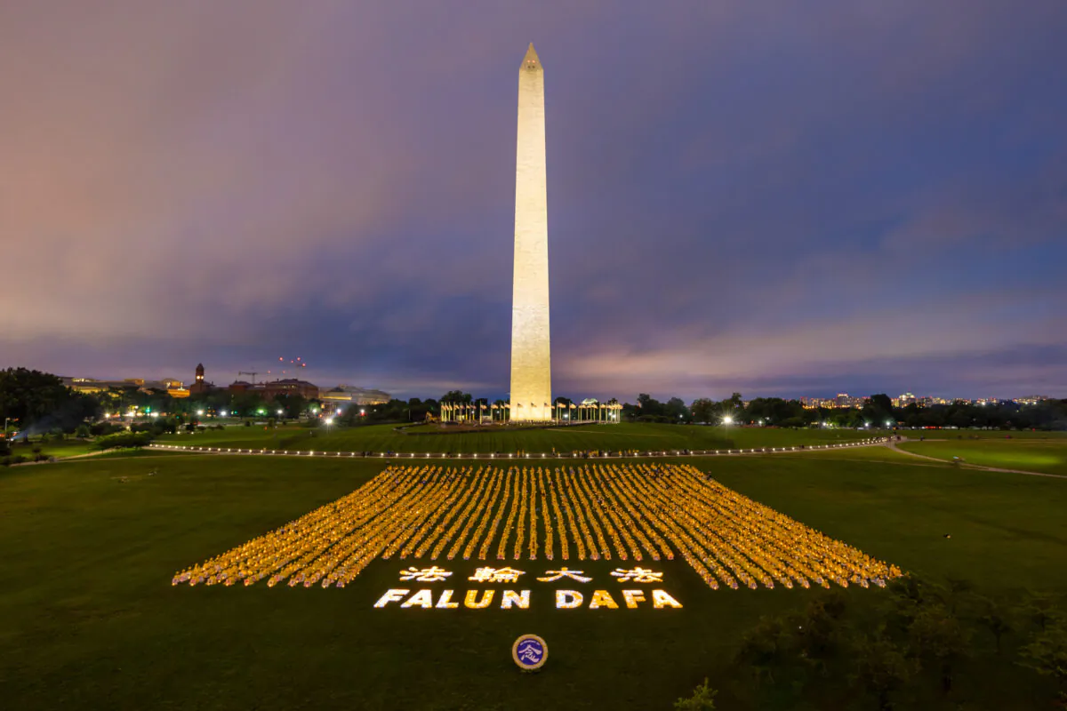 Falun Gong practitioners take part in a candlelight vigil to commemorate the practitioners killed in China for their belief, in Washington on June 22, 2018. (Mark Zou/The Epoch Times)