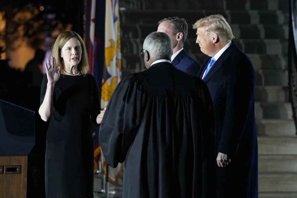 President Donald Trump watches as Supreme Court Justice Clarence Thomas administers the Constitutional Oath to Amy Coney Barrett on the South Lawn of the White House in Washington on Oct. 26, 2020. (Patrick Semansky/AP Photo)