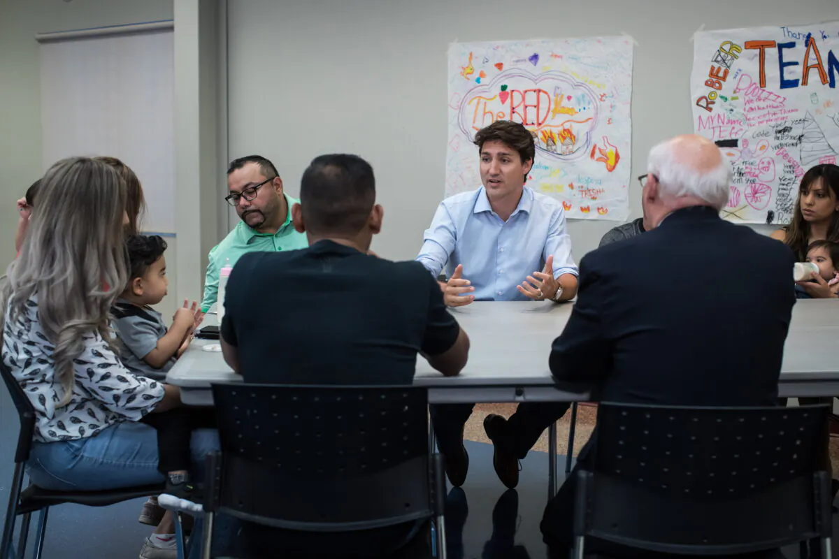Prime Minister Justin Trudeau sits down to speak with families about the Canada Child Benefit during a visit to the Surrey Sport and Leisure Complex, in Surrey, B.C., on July 13, 2019. (The Canadian Press/Darryl Dyck)