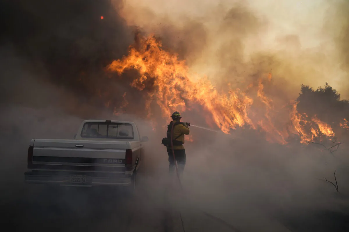 Firefighter Raymond Vasquez battles the Silverado Fire in Irvine, Calif., on Oct. 26, 2020. (Jae C. Hong/AP Photo)