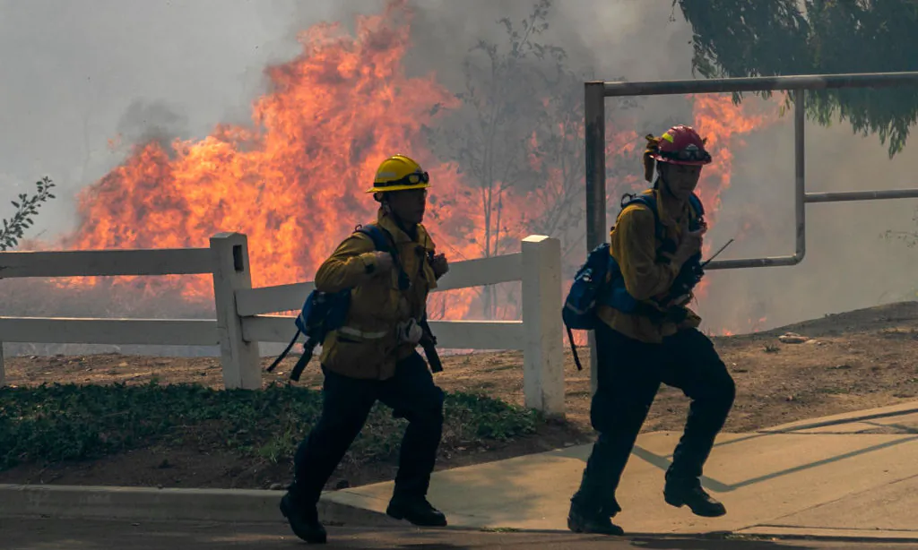 Firefighters react to approaching flames at the Blue Ridge Fire in Yorba Linda, Calif., on Oct. 27, 2020. (David McNew/Getty Images)