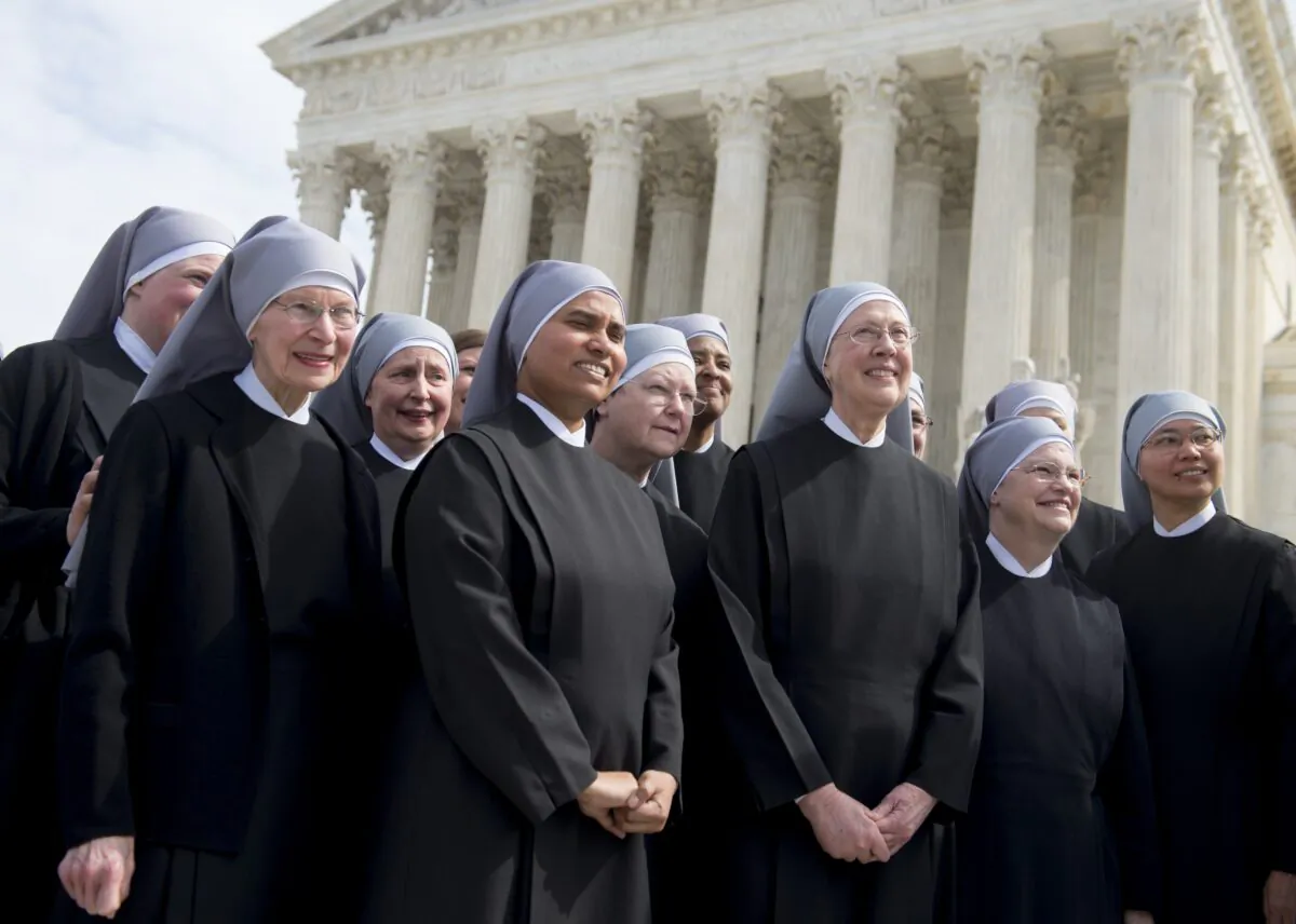 Members of the Little Sisters of the Poor stand outside the Supreme Court following oral arguments in seven cases dealing with religious organizations that want to ban contraceptives from their health insurance policies on religious grounds in Washington on March 23, 2016. (Saul Loeb/AFP via Getty Images)