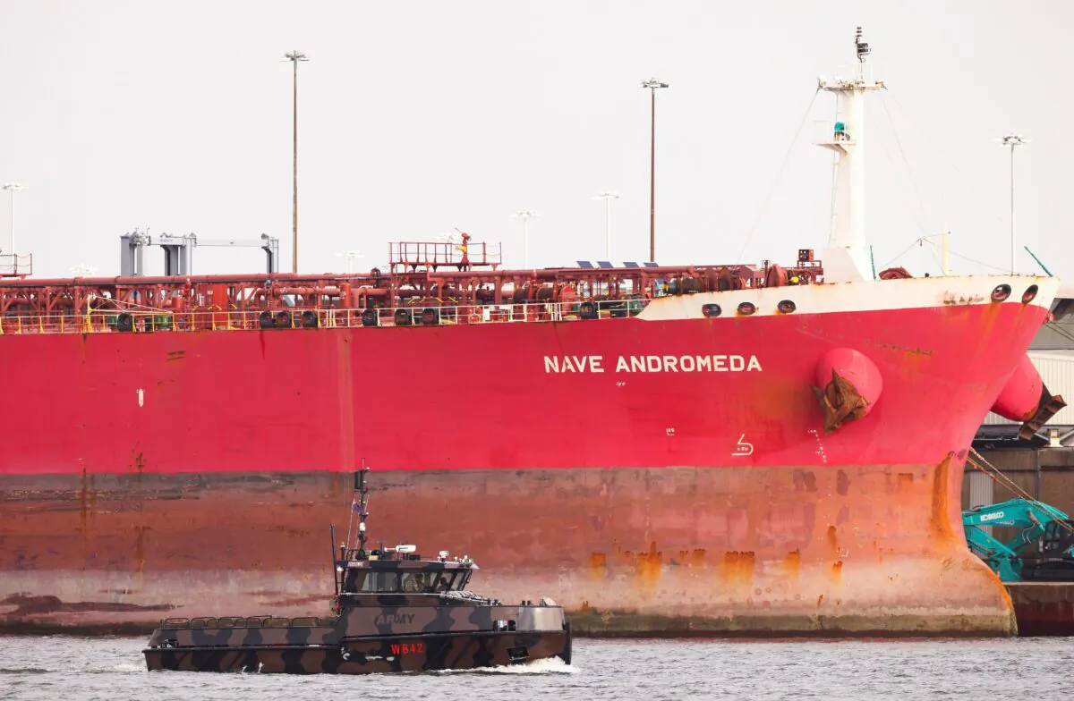 A military boat passes in front of the Liberia-flagged oil tanker Nave Andromeda at Southampton Docks, following a security incident aboard the ship the night before off the coast of Isle of Wight, in Southampton, United Kingdom, on Oct. 26, 2020. (Henry Nicholls/Reuters)