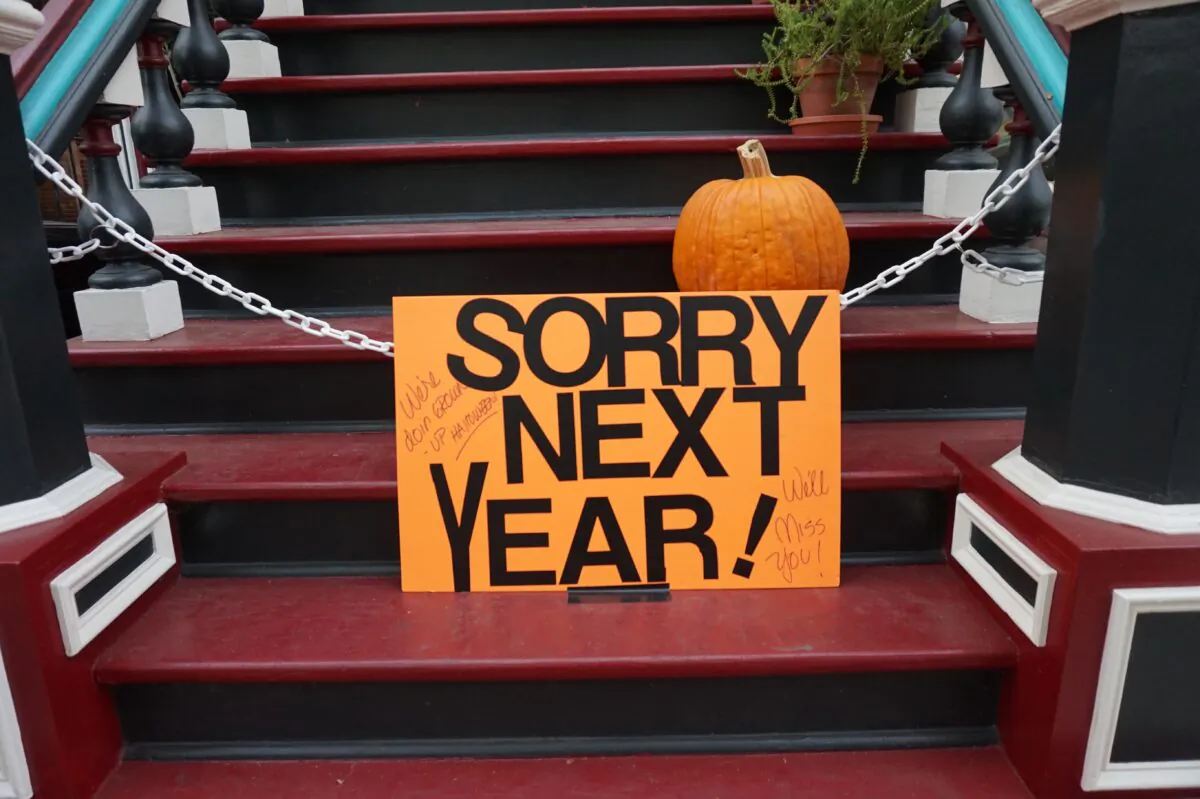 A sign reads 'Sorry next year' on steps outside a home in this file photo. Due to restrictions to slow the spread of the CCP virus, many children will not be able to participate in trick or treating this Halloween. (Ben Shan/Unsplash.com)