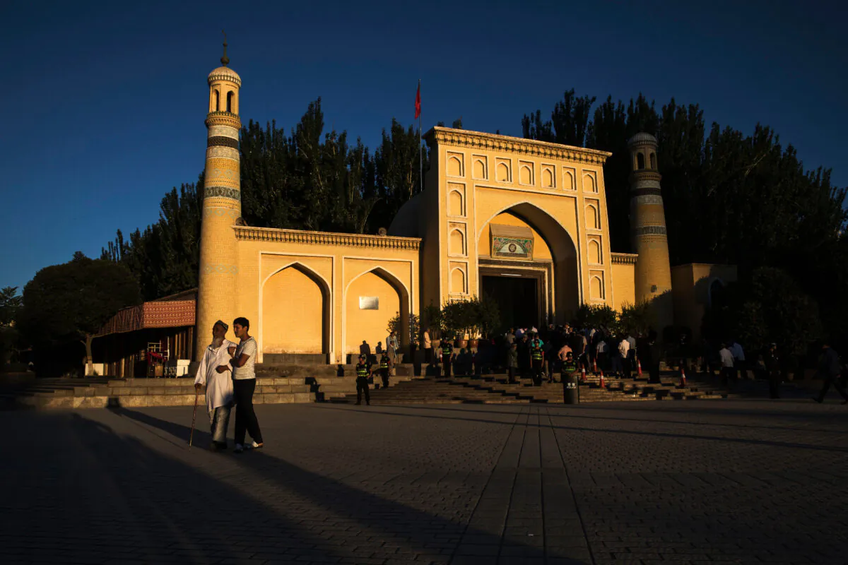 Ethnic Uyghur men leave prayers marking Eid Al Fitr outside Id Kah Mosque in the old town of Kashgar, in the far western Xinjiang region, China, on June 26, 2017. (Kevin Frayer/Getty Images)