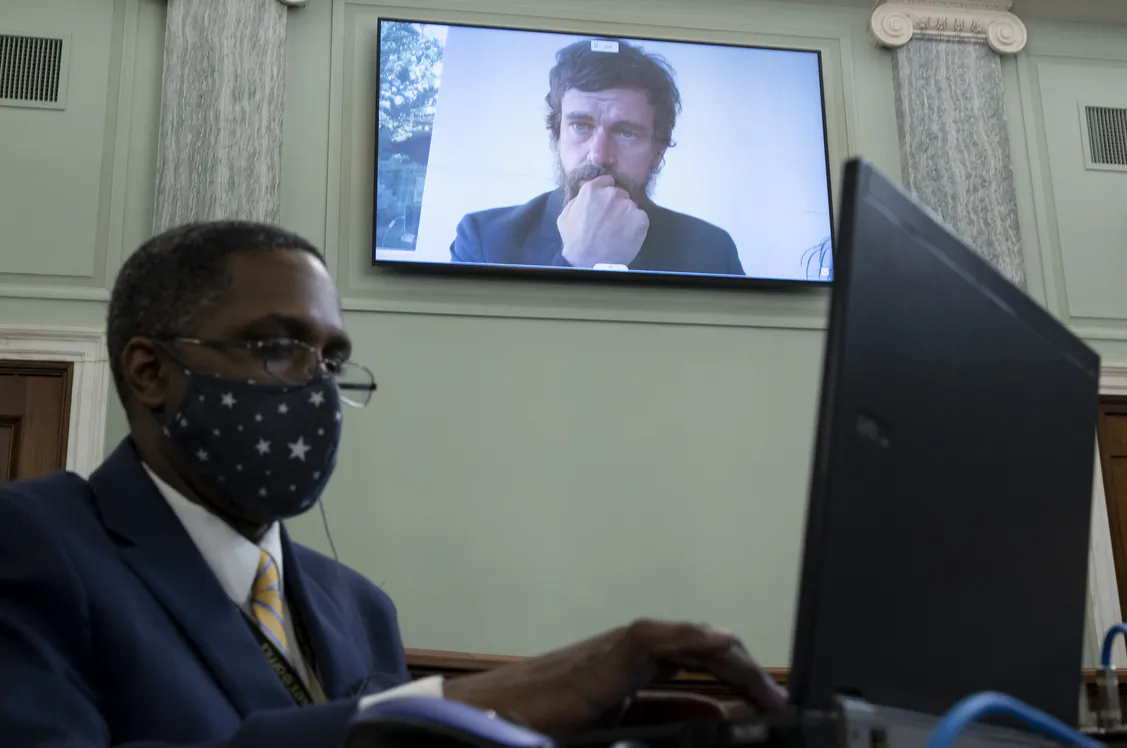 CEO of Twitter Jack Dorsey appears on a monitor behind a stenographer as he testifies remotely during the Senate Commerce, Science, and Transportation Committee hearing on Capitol Hill in Washington on Oct. 28, 2020. (Michael Reynolds-Pool/Getty Images)