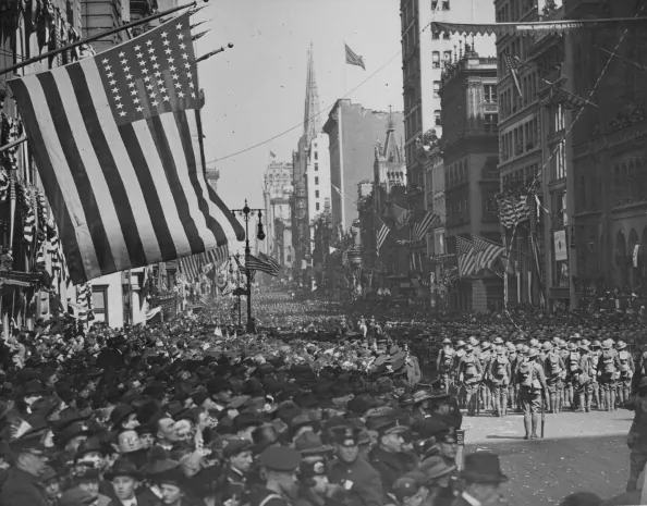 A military parade with crowds of excited spectators along New York’s Fifth Avenue, in celebration of Armistice Day following World War I, November 1918. (Paul Thompson/FPG/Getty Images)