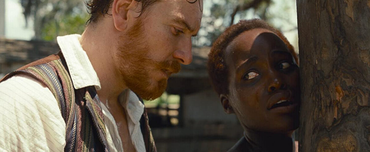 man ties woman to tree in "12 Years a Slave"