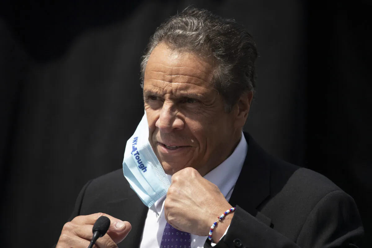 New York Gov. Andrew Cuomo removes a mask as he holds a news conference in Tarrytown, N.Y., on June 15, 2020. (Mark Lennihan, File/AP Photo)