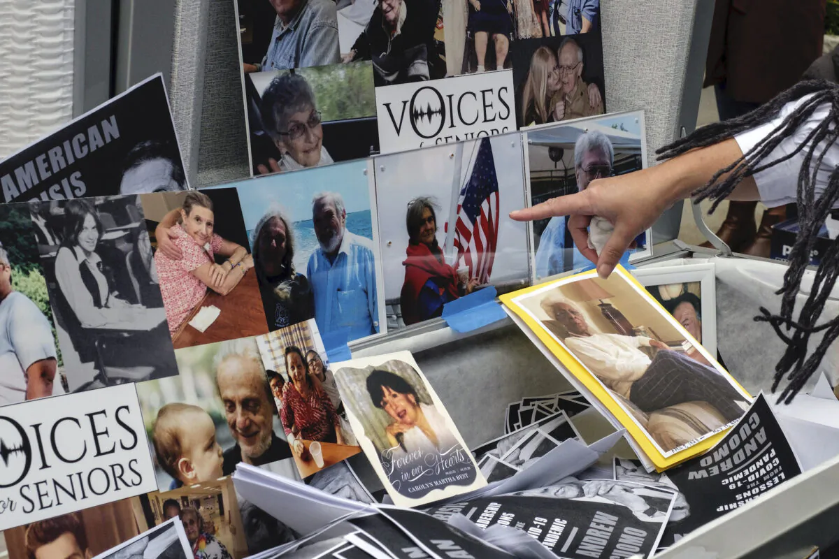 Families of COVID-19 victims who passed away in New York nursing homes gather in front of Cobble Hill Heath Center in Brooklyn, New York, to demand State Governor Andrew Cuomo apologize for his response to clusters in nursing homes during pandemic on Oct. 18, 2020. (Yuki Iwamura/AP Photo)