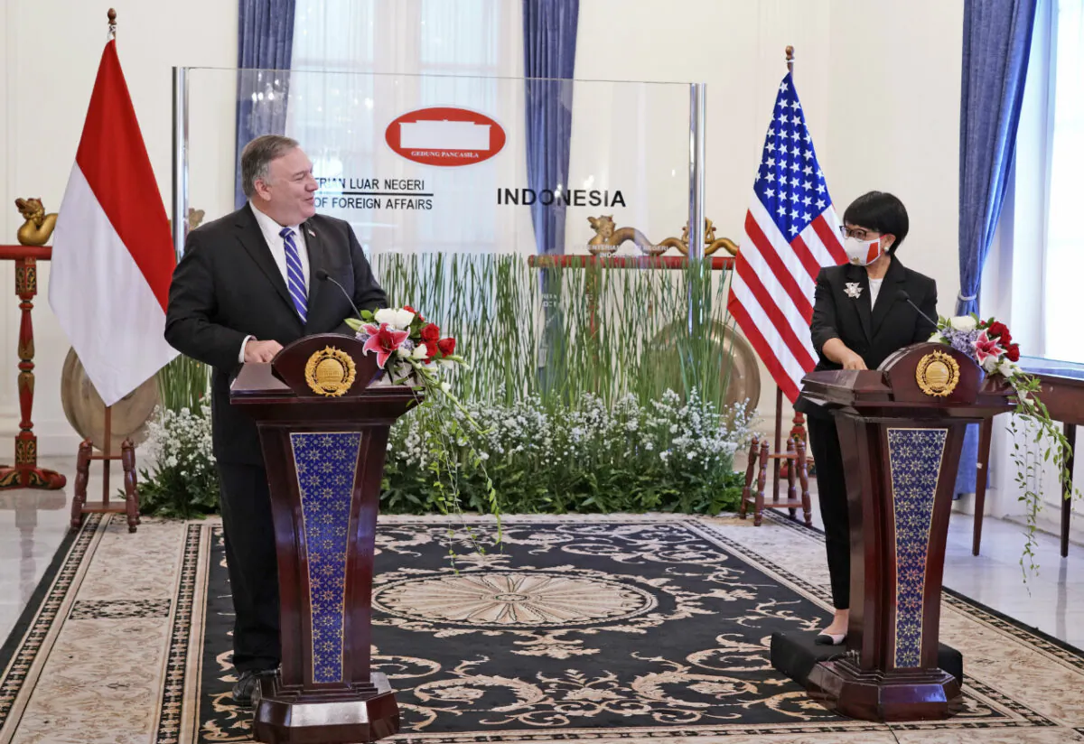 In this photo released by Indonesian Ministry of Foreign Affairs, U.S. Secretary of State Mike Pompeo, left, talks to Indonesian Foreign Minister Retno Marsudi during a joint press conference which was broadcasted online in Jakarta, Indonesia, Thursday, Oct. 29, 2020. (Indonesian Ministry of Foreign Affairs via AP)