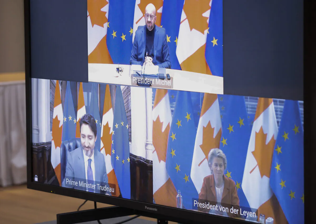 European Council President Charles Michel (top) speaks to Canadian Prime Minister Justin Trudeau and European Commission President Ursula von der Leyen, bottom via video link during an EU-Canada summit at the European Council building in Brussels on Oct. 29, 2020. (Olivier Hoslet, Pool/The Associated Press)