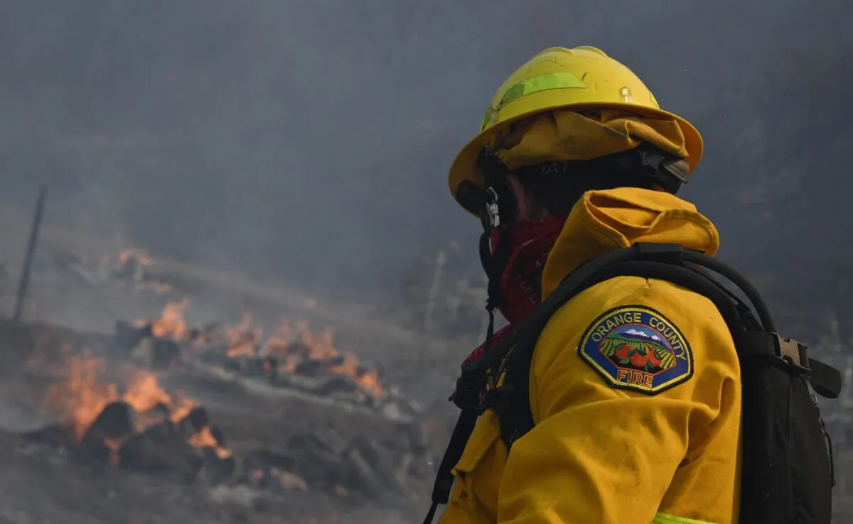 An Orange County firefighter looks for hotspots near a residential area in the Silverado Fire October 26, 2020, in Irvine, Calif. (Robyn Beck/AFP via Getty Images)