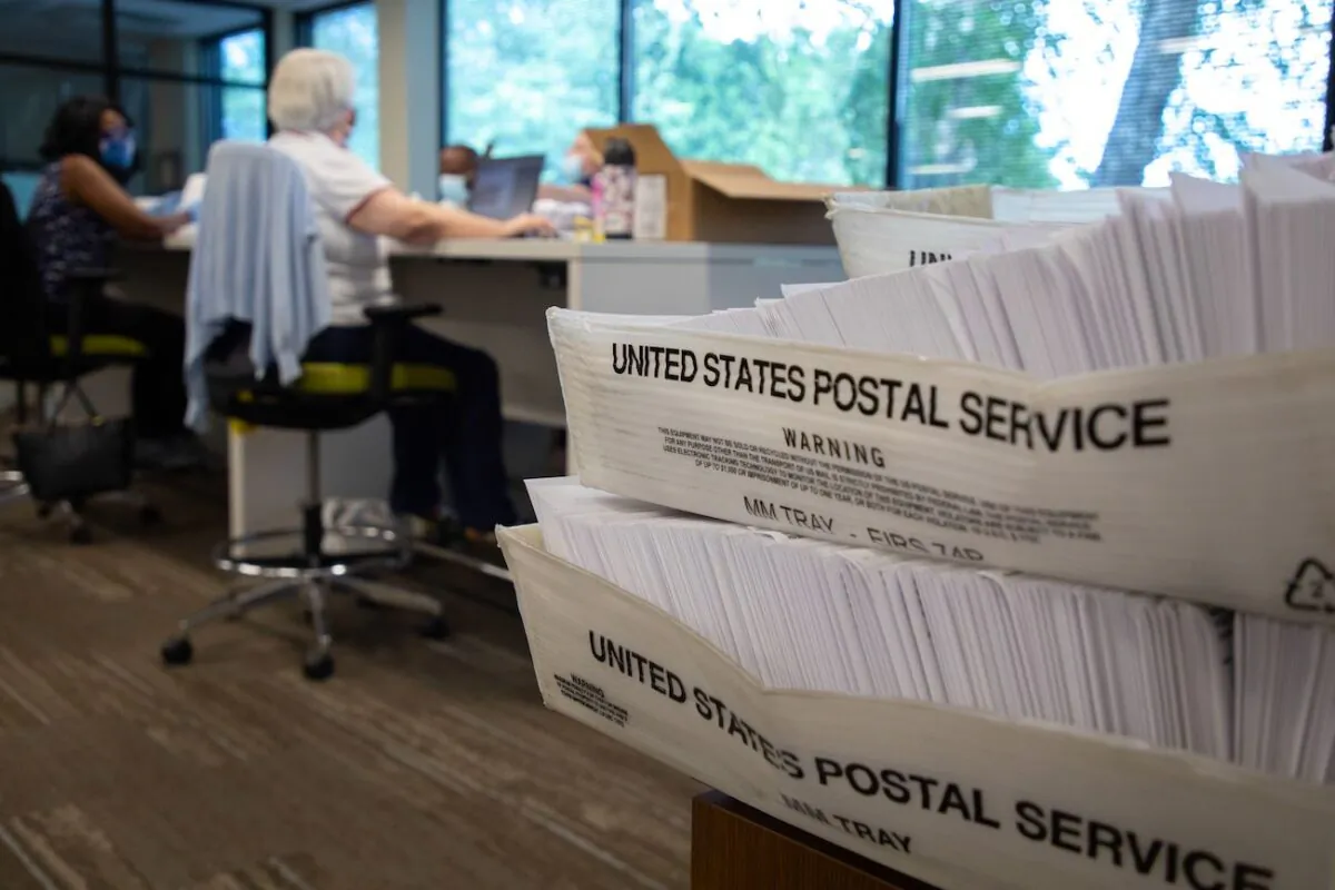 Large boxes of envelopes are seen as absentee ballot election workers stuff ballot applications at the Mecklenburg County Board of Elections office in Charlotte, North Carolina, on Sept. 4, 2020. (Logan Cyrus/AFP via Getty Images)