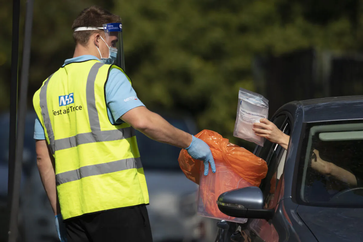 A worker collects a swab test from a member of the public at a COVID Test site in South London on Sept. 15, 2020 ( Dan Kitwood/Getty Images)