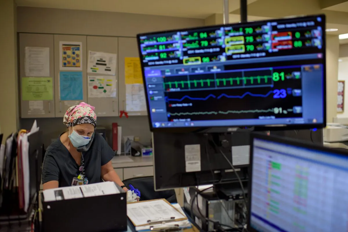 A health care worker answers the phone in the ER at Oakbend Medical Center in Richmond, Texas, on July 15, 2020. (Mark Felix/AFP /AFP via Getty Images)