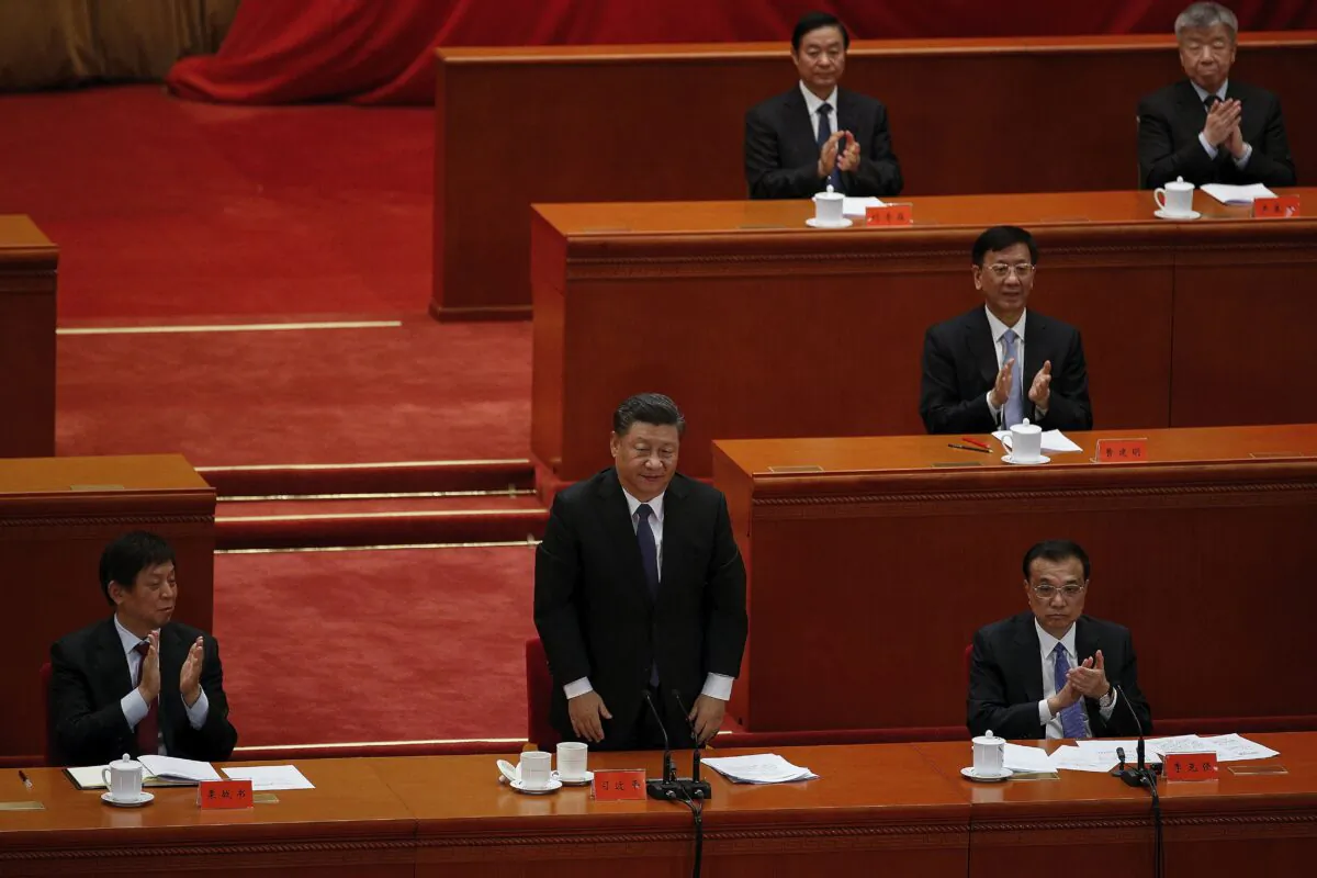 Chinese Communist Party officials applaud as leader Xi Jinping delivers his speech commemorating the 70th anniversary of the Chinese army entering North Korea, at the Great Hall of the People in Beijing on Oct. 23, 2020. (AP Photo/Andy Wong)