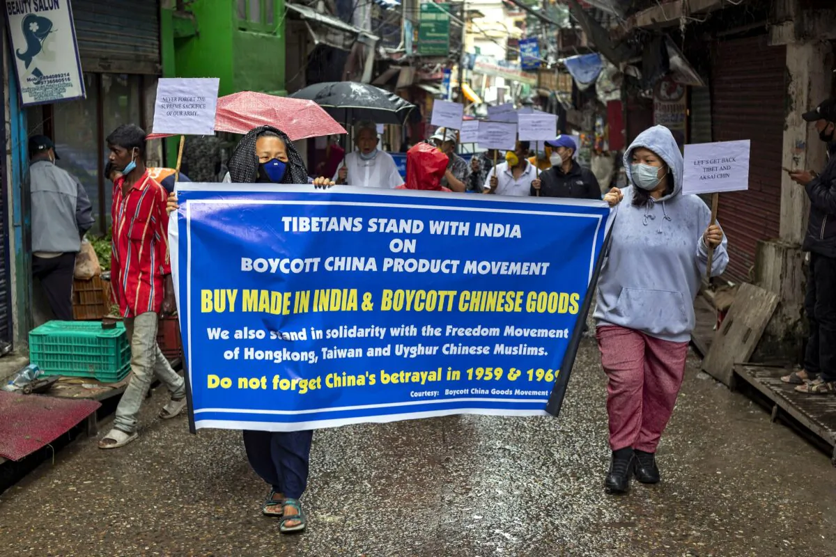 Exiled Tibetans hold placards during a protest march in support of the boycott of Chinese-made goods, in Dharmsala, India, on July 21, 2020. (AP Photo/Ashwini Bhatia)