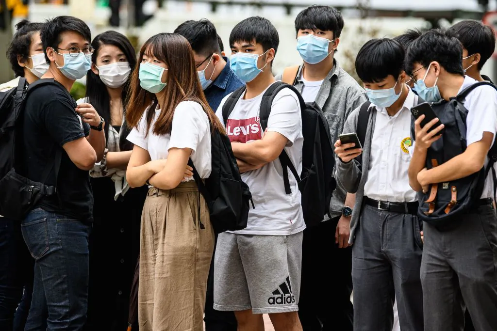 Young supporters wait outside the West Kowloon Magistrates Court in Hong Kong on Oct. 29, 2020, after local teenage democracy activist Tony Chung, 19, was charged with secession under the new national security law. (Anthony Wallace/AFP via Getty Images)