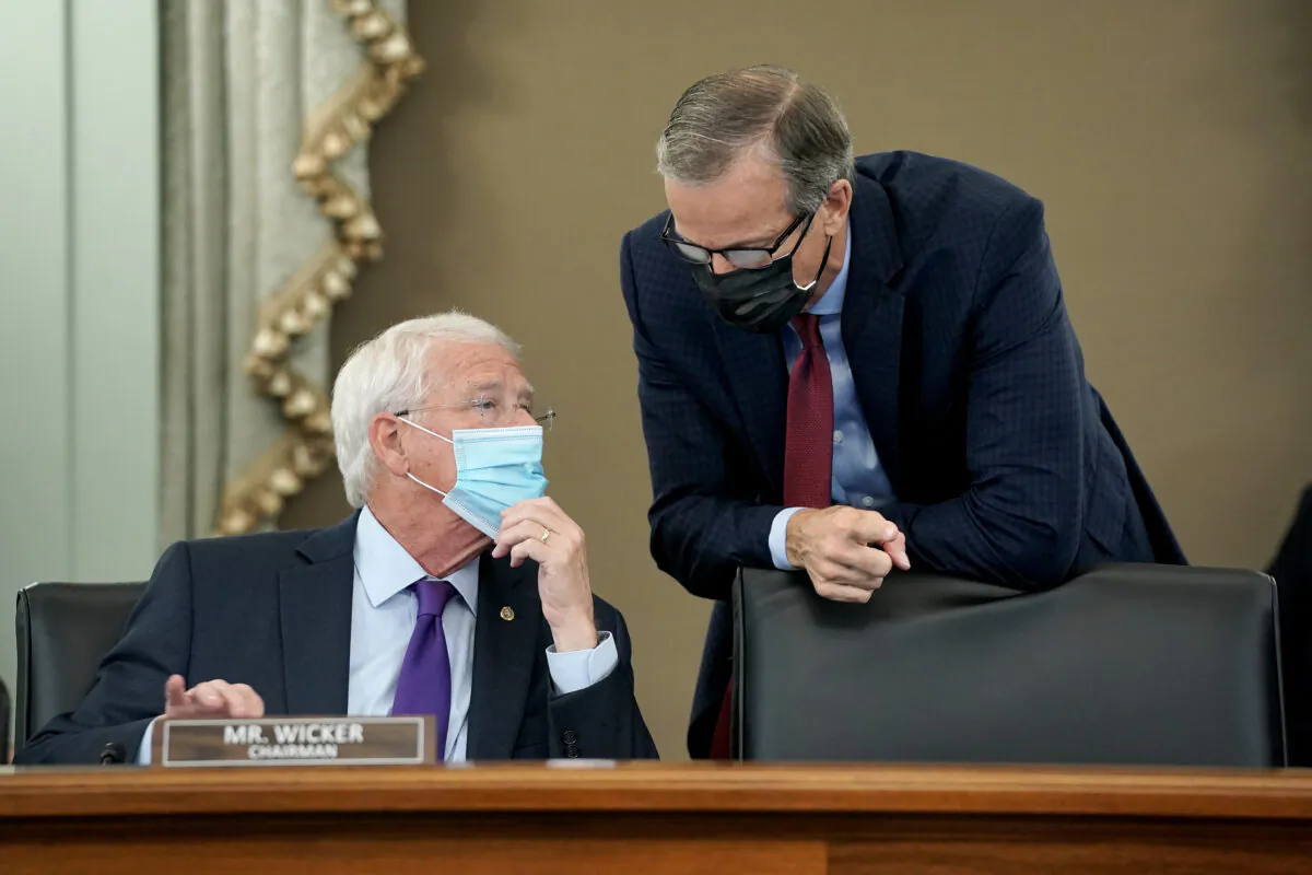 Chairman Sen. Roger Wicker (R-MS) speaks to Sen. John Thune (R-SD) during a Senate Commerce, Science, and Transportation Committee hearing with big tech companies on Capitol Hill in Washington on Oct. 28, 2020. (Greg Nash-Pool/Getty Images)