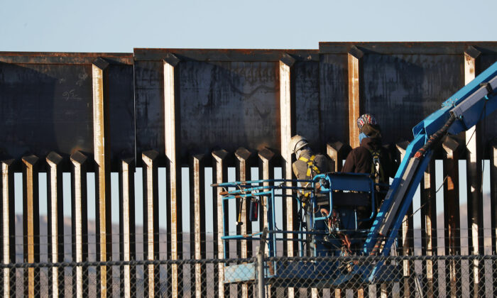 People work on the U.S.-Mexico border wall in El Paso, Texas, on Feb. 12, 2019. (Joe Raedle/Getty Images)