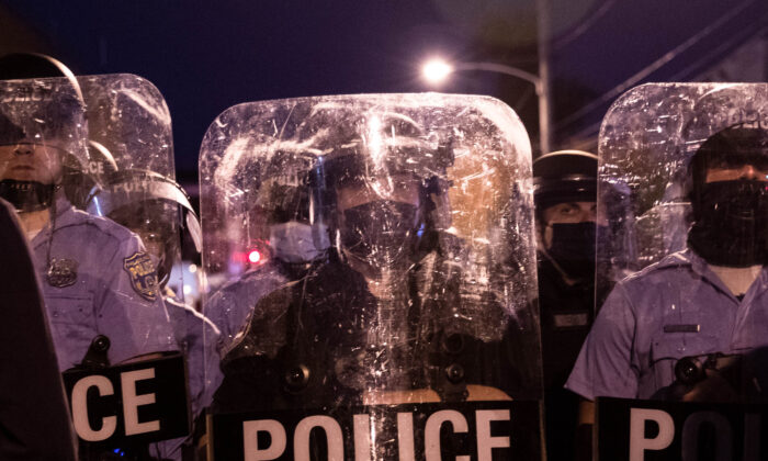 Police in riot gear face protesters marching through West Philadelphia on Oct. 27, 2020. (Gabriella Audi/AFP via Getty Images)