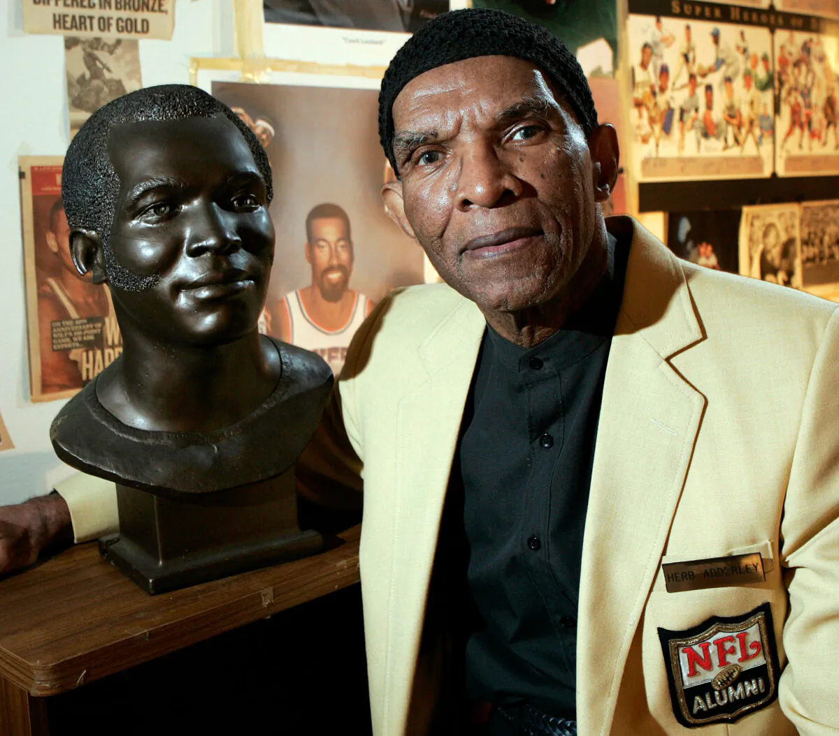 Former NFL player Herb Adderley poses next to a copy of his Hall of Fame bust in a room full of memorabilia from his playing days at his home in Mantua, N.J., on Oct. 2, 2008. (Mel Evans/AP Photo, File)