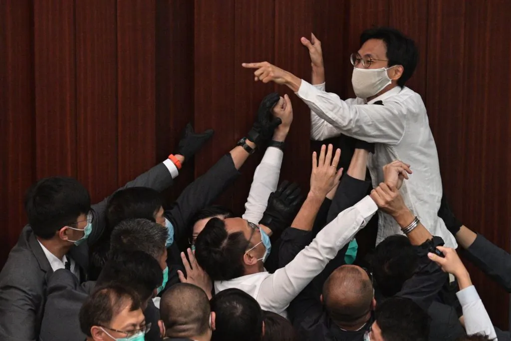 Pro-democracy lawmaker Eddie Chu Hoi-dick (top C) shouts at security trying to restrain at the Legislative Council in Hong Kong on May 8, 2020. (Anthony Wallace/AFP via Getty Images)