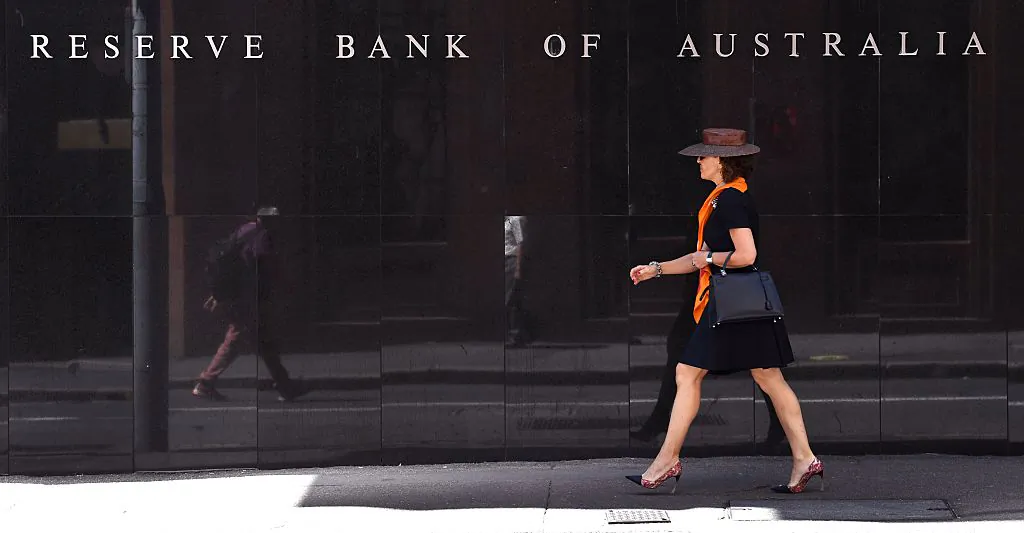 A woman walks past the Reserve Bank of Australia sign in Sydney on October 4, 2016. (William West/AFP via Getty Images)