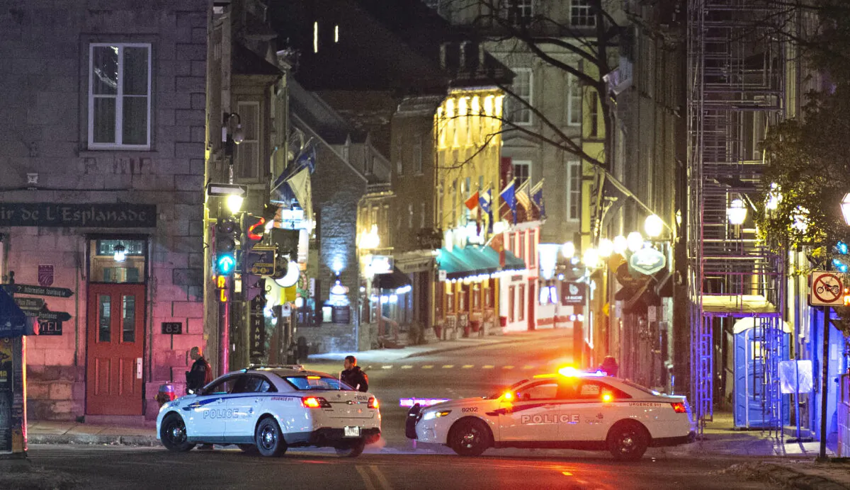 Police cars block the Saint-Louis Street near the Chateau Frontenac in Quebec City, Canada, early on Nov. 1, 2020. (Jacques Boissinot/The Canadian Press via AP)
