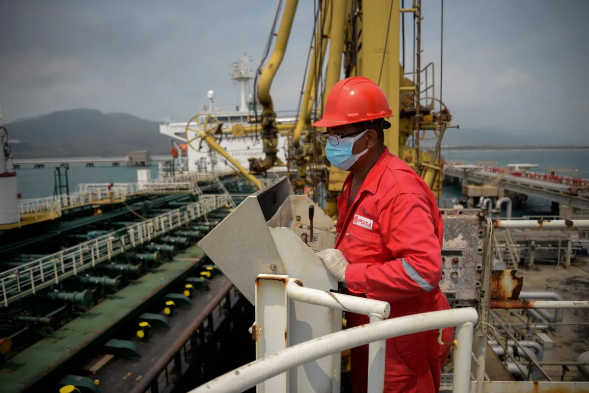A worker of the Venezuelan state oil company PDVSA looks at the Iranian-flagged oil tanker Fortune as it docks at the El Palito refinery in Puerto Cabello in the northern state of Carabobo, Venezuela, on May 25, 2020. (AFP via Getty Images)