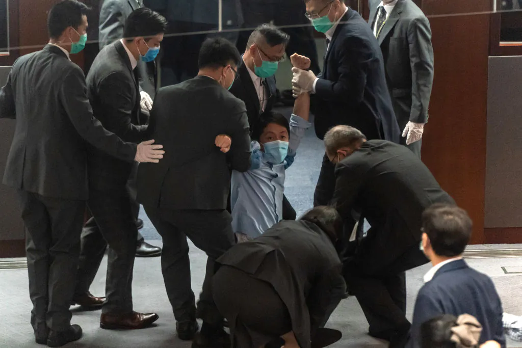 Pro-democracy lawmaker Ted Hui Chi-fung is removed by security during a scuffle with pro-Beijing lawmakers at the Legislative Council in Hong Kong on May 22, 2020. (Anthony Kwan/Getty Images)