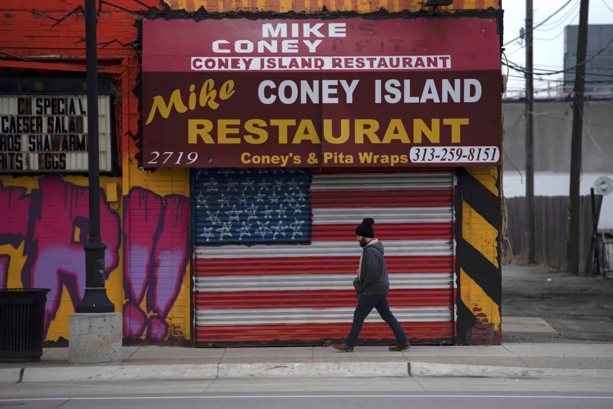 A man passes a closed restaurant in Detroit, Mich., on March 24, 2020. (Seth Herald/AFP via Getty Images)