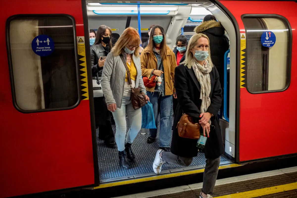 Commuters wear face-masks during morning rush hour on the Victoria Line of the London Underground in central London on Oct. 16, 2020. (Tolga Akmen/AFP via Getty Images)