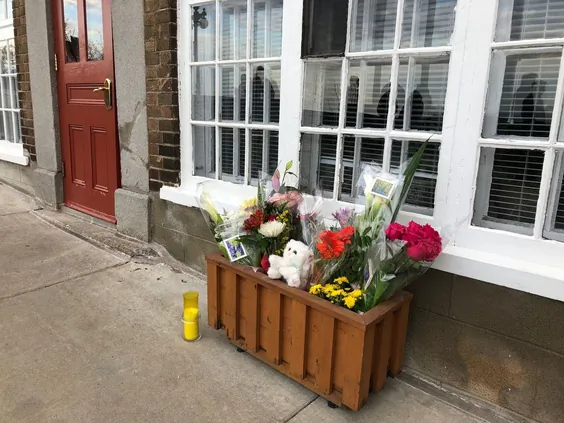 Flowers and a candle are placed in front of the house of a woman who died in the Halloween attack on Oct. 31, 2020, in Quebec City. (Anne-Sophie Thill/AFP via Getty Images)