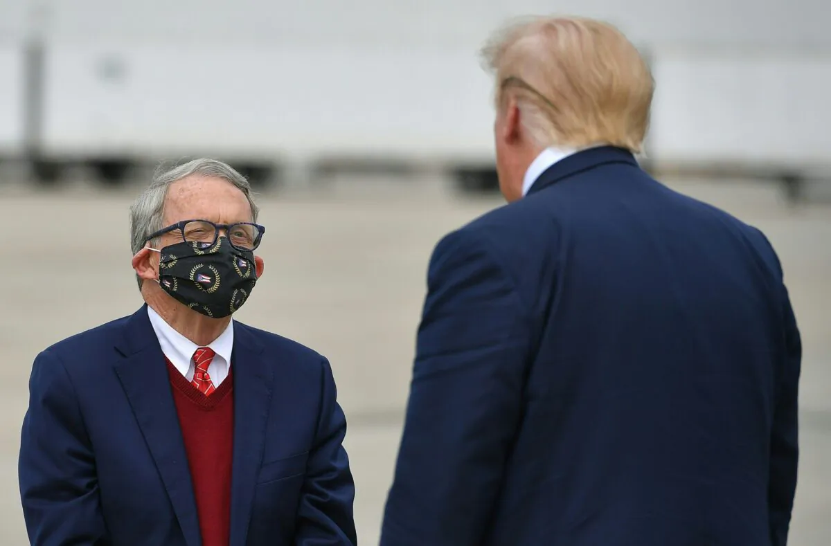 President Donald Trump speaks with Ohio Gov. Mike DeWine upon arrival at Rickenbacker International Airport in Columbus, Ohio on Oct. 24, 2020. (Mandel Ngan/AFP via Getty Images)