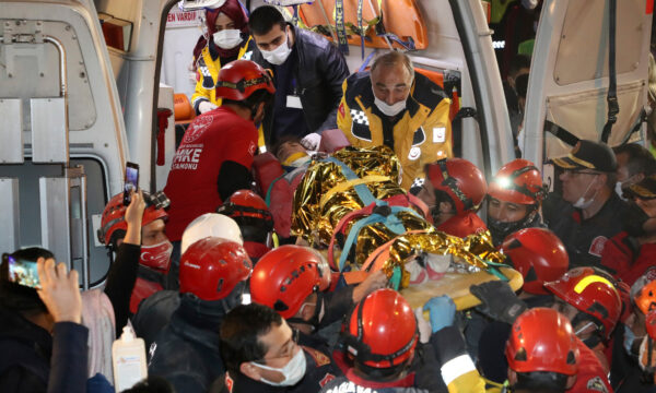Rescue workers, who were trying to reach survivors in the rubble of a collapsed building, carry to an ambulance 14-year-old Idil Sirin