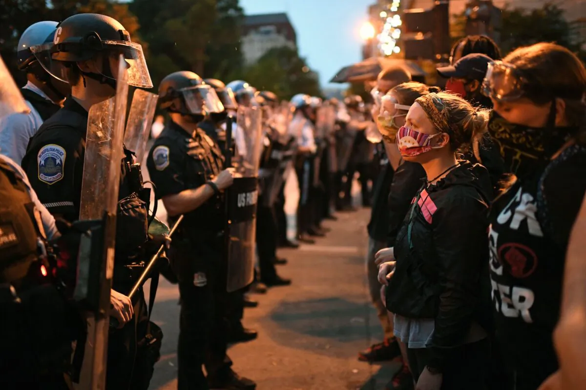 Protesters confront a row of police officers at Lafayette square, in front of the White House, in Washington on June 22, 2020. (Eric Baradat/AFP via Getty Images)