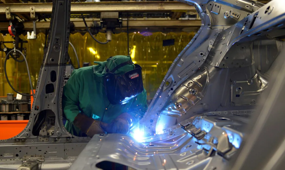 Line workers spot weld parts of the frame on the flex line at Nissan Motor Co's automobile manufacturing plant in Smyrna, Tenn., on Aug. 23, 2018. (William DeShazer/Reuters)