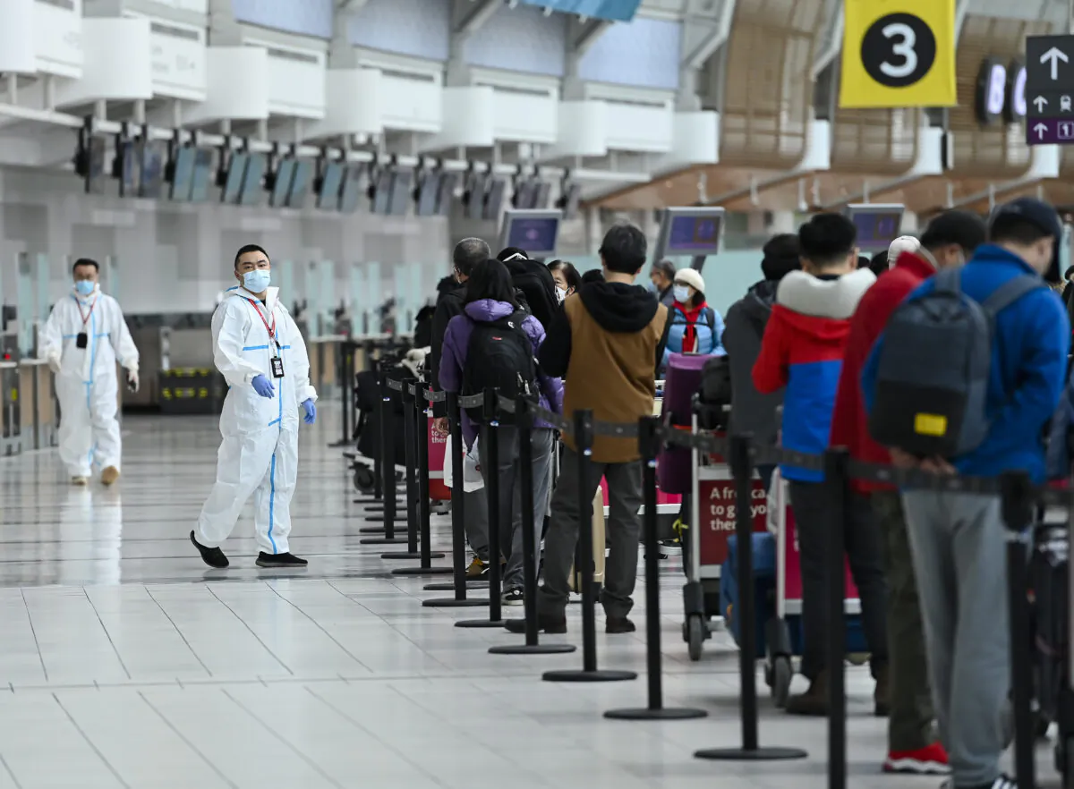 People line up and check in for an international flight at Pearson International airport during the COVID-19 pandemic in Toronto on Wednesday, Oct. 14, 2020. (THE CANADIAN PRESS/Nathan Denette)