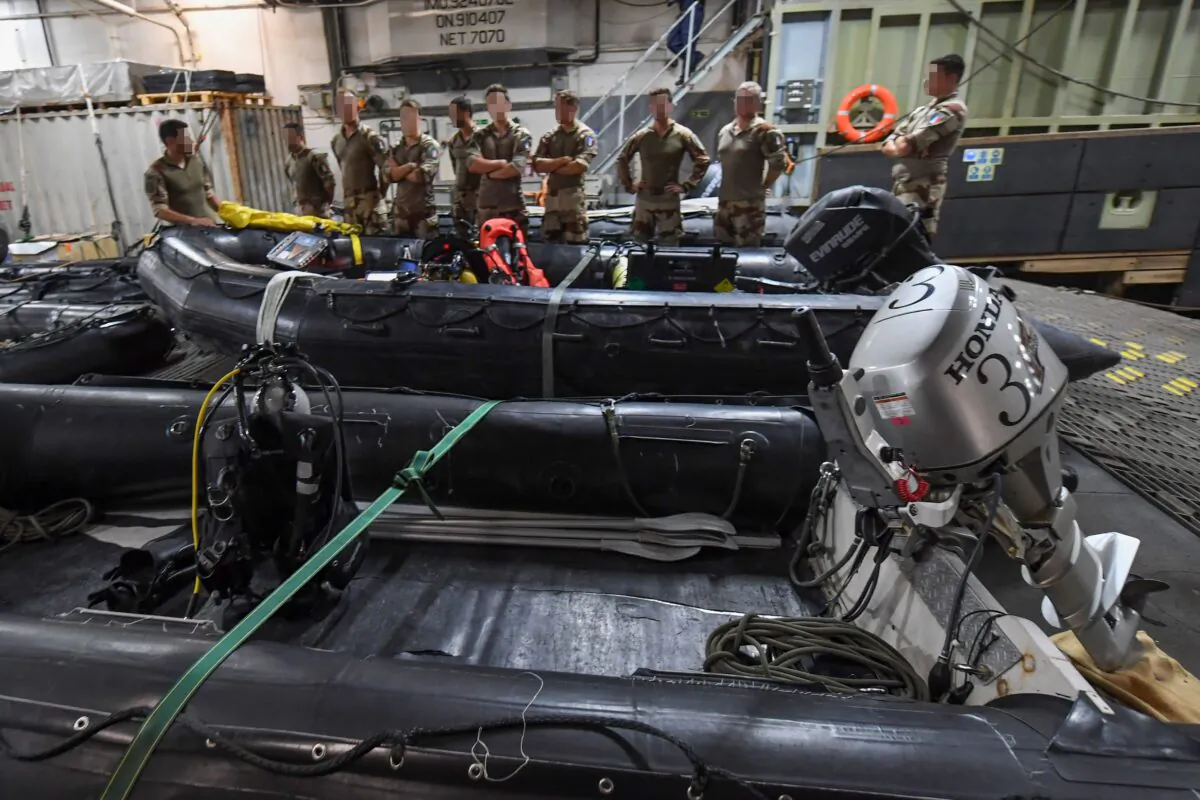 French divers aboard Britain's RFA Cardigan Bay landing ship in the Gulf waters off Bahrain stand next to a rigid-hull inflatable boat during the International Maritime Exercise, on Nov. 5, 2019. (KARIM SAHIB/AFP via Getty Images)